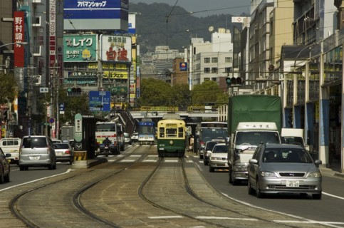 JAPAN, Kyushu, Nagasaki, Kanko dori - cars tram and tramlines in main downtown shopping street