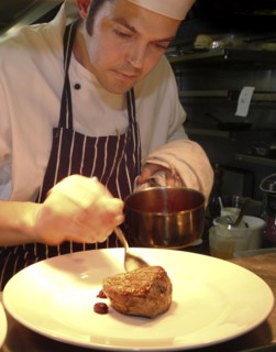 ENGLAND, Bristol, Bristol, Chef Plating Up Fillet Steak and Raspberry Coulis