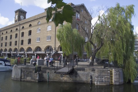 ENGLAND, London, St Catherines dock former warehouses now luxury  apartments. Extending foobridge