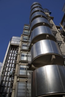 ENGLAND, London, Lloyds of London building polished metal exterior with elevators on the outside.