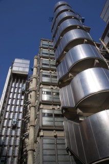 ENGLAND, London, Lloyds of London building polished metal exterior with elevators on the outside.