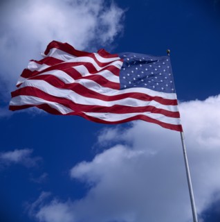 USA, Flags, American Stars and Stripes National Flag blowing in the wind against a blue sky with