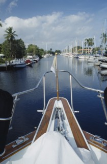 USA, Florida, Fort Lauderdale, View of Canal from boats bow with yachts moored outside waterfront
