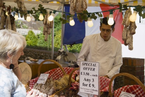 ENGLAND, West Sussex, Shoreham-by-Sea, French Market. Selection of sausages on display in baskets