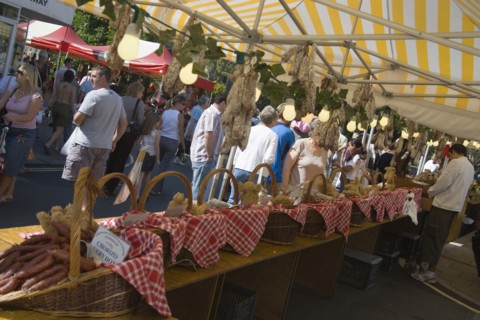 ENGLAND, West Sussex, Shoreham-by-Sea, French Market. Yellow and white striped covered market stall