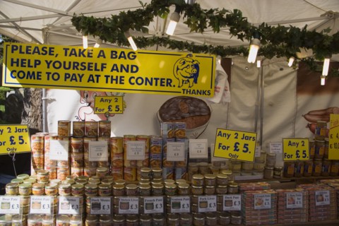 ENGLAND, West Sussex, Shoreham-by-Sea, French Market. Stall with a selection of jars and tinned