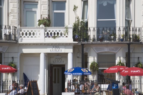 ENGLAND, West Sussex, Worthing, The Last Resort seafront bar exterior with people sitting under