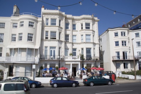 ENGLAND, West Sussex, Worthing, The Last Resort seafront bar exterior with people sitting  under