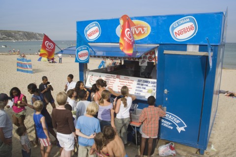 ENGLAND, Dorset, Swanage Bay, A group of children queuing at Ice Cream stall