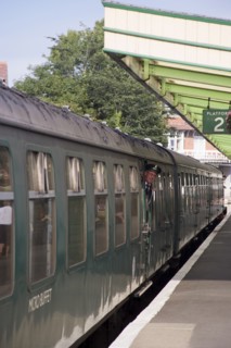 ENGLAND, Dorset, Swanage, Steam Railway Station. View along platform with train departing from