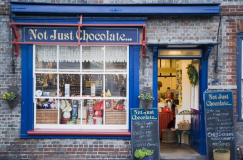 ENGLAND, East Sussex, Alfriston, Not Just Chocolate confectionary shop opposite the market cross.