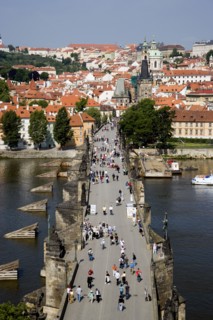 CZECH REPUBLIC, Bohemia, Prague, People walking across the Charles Bridge across the Vltava River