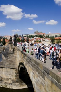 CZECH REPUBLIC, Bohemia, Prague, Tourists on the Charles Bridge across the Vltava River with Prague