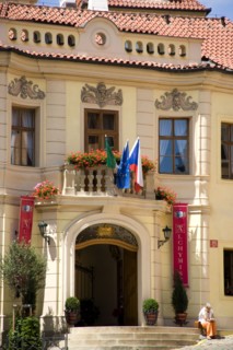 CZECH REPUBLIC, Bohemia, Prague, Woman sitting on the steps up to the Residence Hotel de Charme in