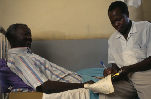TANZANIA, Shinyanga, Doctor taken patients notes in regional hospital.