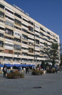 KAZAKHSTAN, Almatr, Street scence with people selling paintings in front of shops and apartrments.