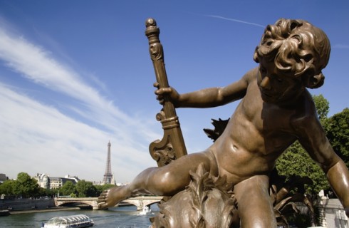 FRANCE, Ile de France, Paris, Bronze statue of a cherub on the Pont Alexandre III bridge over the