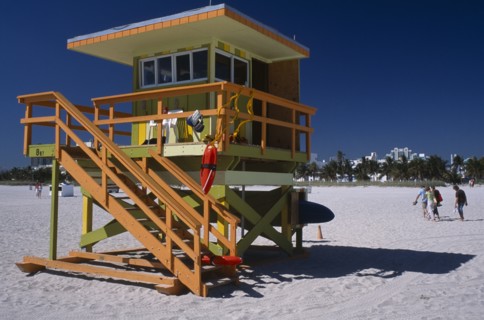 USA, Florida, Miami, South Beach. Ocean Drive. Orange and Green Lifeguard station on sandy beach