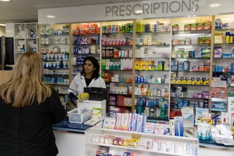 ENGLAND, East Sussex, Shoreham by sea, Interior of high street dispensing chemist  with female