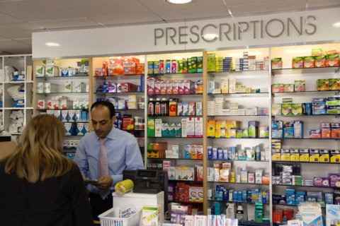 ENGLAND, East Sussex, Shoreham by sea, Interior of high street dispensing chemist  with female