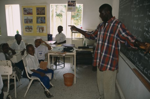 NIGERIA, Kano, Teacher and pupils in classroom of private school.
