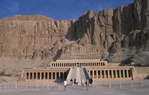 EGYPT, Nile Valley, Thebes, Deir el-Bahri. Hatshepsut Mortuary Temple. Visitors walking towards