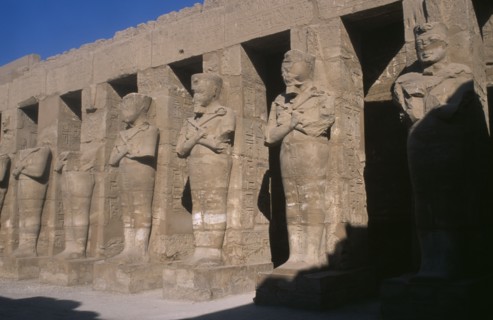 EGYPT, Nile Valley, Karnak, Temple of Amun. Osiride Pillars. Statues with crossed arms bearing the