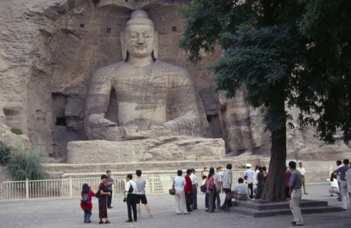 CHINA, Shanxi, Datong, Yungang Caves.  Chinese visitors at ancient Buddhist site with rock carvings