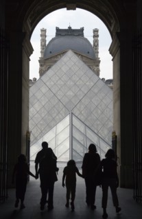 FRANCE, Ile de France, Paris, Tourist family passing through the Richelieu wing of the Louvre