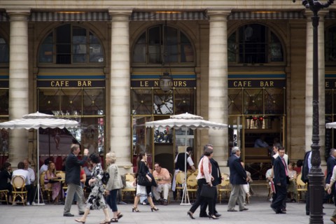 FRANCE, Ile de France, Paris, People at tables with pedestrians walking past outside the Cafe Bar