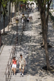 FRANCE, Ile de France, Paris, Montmartre People on the tree lined steps of the Rue Foyatier beside