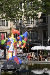 FRANCE, Ile de France, Paris, People sitting at tables under umbrellas beside the colourful