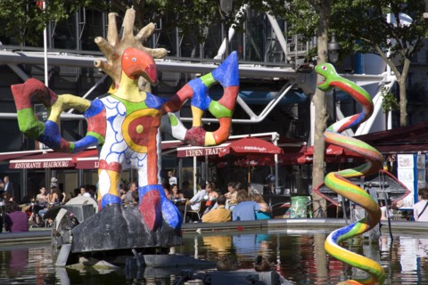 FRANCE, Ile de France, Paris, People sitting at tables under umbrellas beside the colourful