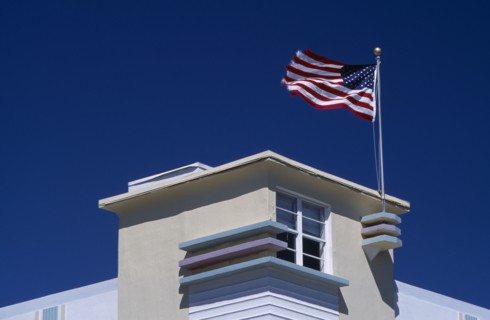 USA, Florida, Miami, South Beach. Ocean Drive. Detail of an Art Deco building with an American flag