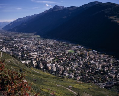 SWITZERLAND, Valais, Martigny, Elevated view east along Rhone Valley above Vineyards and town