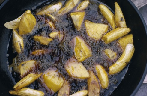 NIGERIA, Food, Cassava and plantain frying in oil.