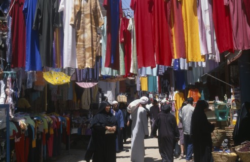 EGYPT, Nile Valley, Luxor, Sharia el-Souk street in the main market / bazaar. Men and women walking