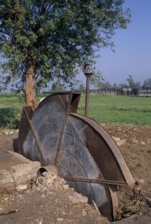 EGYPT, Agriculture , A disused water pump with fields behind