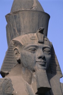 EGYPT, Nile Valley, Luxor, Luxor Temple. Ramses II seated statue with detail of head