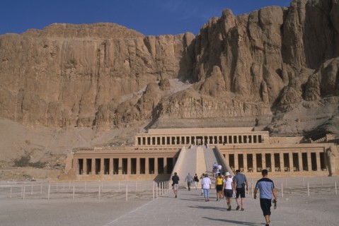 EGYPT, Nile Valley, Thebes, Deir el-Bahri. Hatshepsut Mortuary Temple. Visitors walking towards