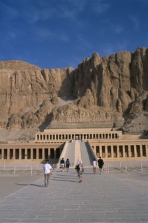 EGYPT, Nile Valley, Thebes, Deir el-Bahri. Hatshepsut Mortuary Temple. Visitors walking towards
