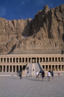 EGYPT, Nile Valley, Thebes, Deir el-Bahri. Hatshepsut Mortuary Temple. Visitors walking towards