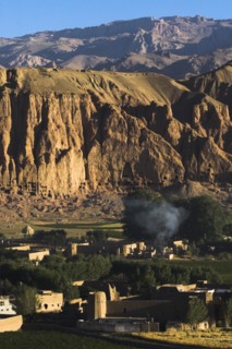 AFGHANISTAN, Bamiyan Province, Bamiyan, Village at base of cliffs near empty niche where the famous