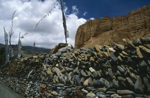 NEPAL, Mustang, Drakhmar, Prayer wall made from stacked stones engraved with prayers and with
