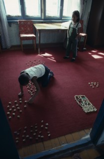 MONGOLIA, Children, Children playing indoors with sheep knuckle bones used to represent herds and