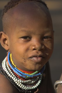 ETHIOPIA, Lower Omo Valley, Mago National Park, Karo girl wearing colourful necklaces.