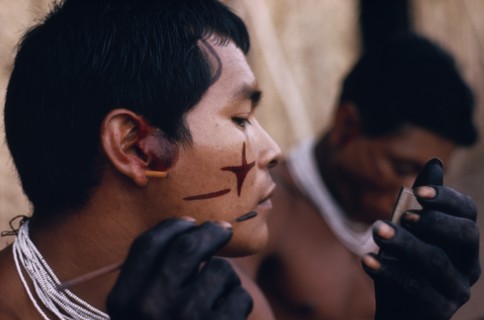 COLOMBIA, North West Amazon, Tukano Indigenous People, Barasana man looking in traded mirror to