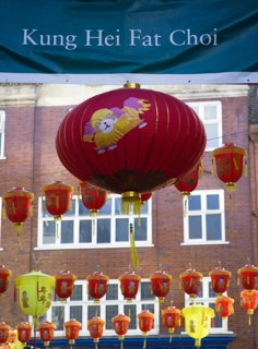 ENGLAND, London, Chinatown, Lion Dance troupe and musicians performing in Wardour Street amongst