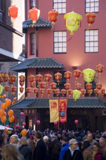 ENGLAND, London, Chinatown, Lion Dance troupe and musicians performing in Wardour Street amongst