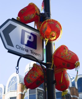 ENGLAND, London, Chinatown, Lion Dance troupe and musicians performing in Wardour Street amongst